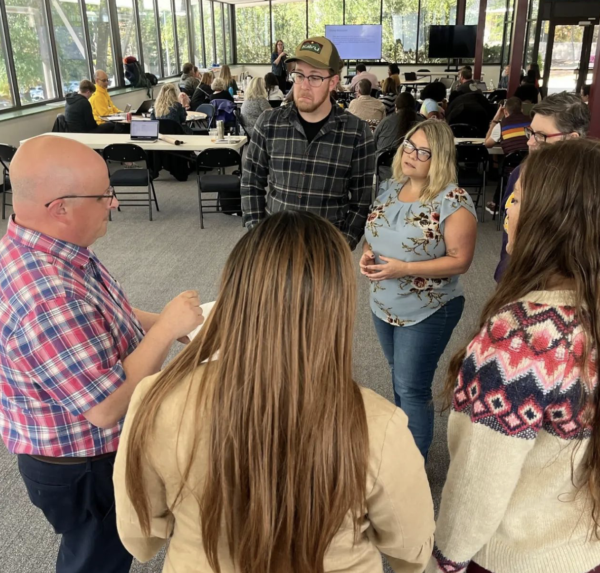 A circle of teachers talking together